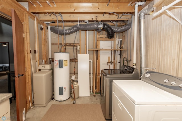 laundry area with water heater and washer and clothes dryer