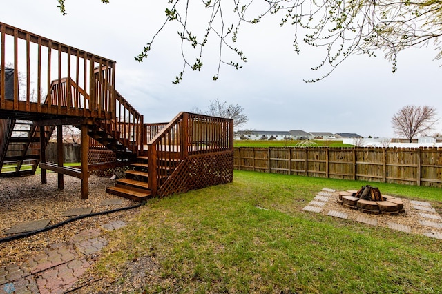 view of yard with a fire pit, stairs, and a deck