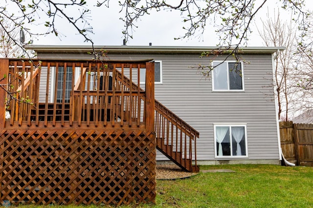 back of house featuring a wooden deck and stairway