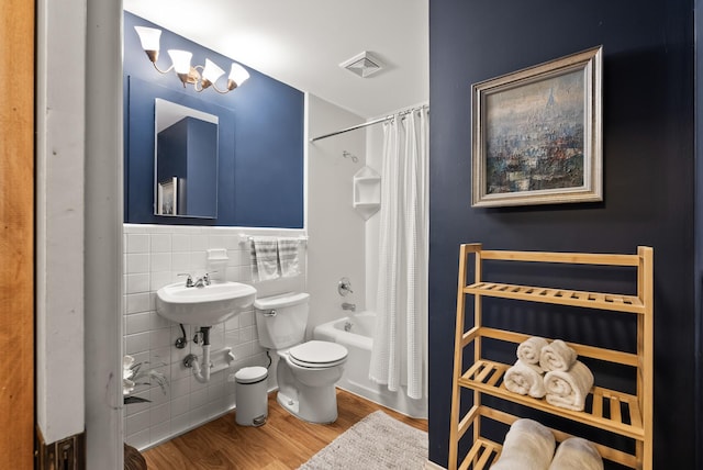 4236 Salem Ave, Saint Louis Park, MN 55416 - bathroom with toilet, wood finished floors, tile walls, shower / tub combo, and wainscoting