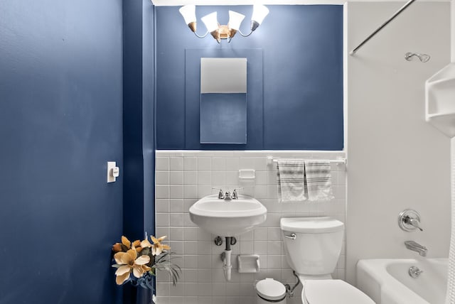 4236 Salem Ave, Saint Louis Park, MN 55416 - full bathroom featuring toilet, a chandelier, tile walls, wainscoting, and tub / shower combination