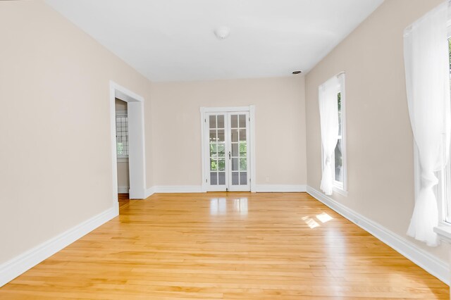 4304 Colfax Ave S, Minneapolis, MN 55409 - empty room featuring light wood-type flooring, baseboards, and french doors