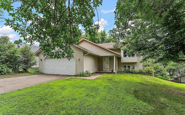 9013 91st St S, Cottage Grove, MN 55016 - split level home with an attached garage, driveway, and a front lawn