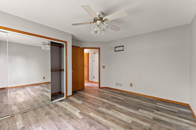 9013 91st St S, Cottage Grove, MN 55016 - unfurnished bedroom with wood finished floors, a closet, and ceiling fan