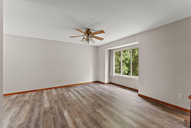 9013 91st St S, Cottage Grove, MN 55016 - spare room featuring ceiling fan, wood finished floors, and a textured ceiling