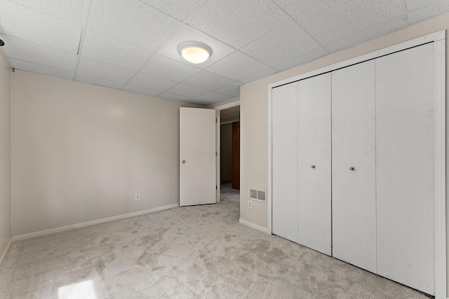 9013 91st St S, Cottage Grove, MN 55016 - unfurnished bedroom with light colored carpet, a closet, and a paneled ceiling