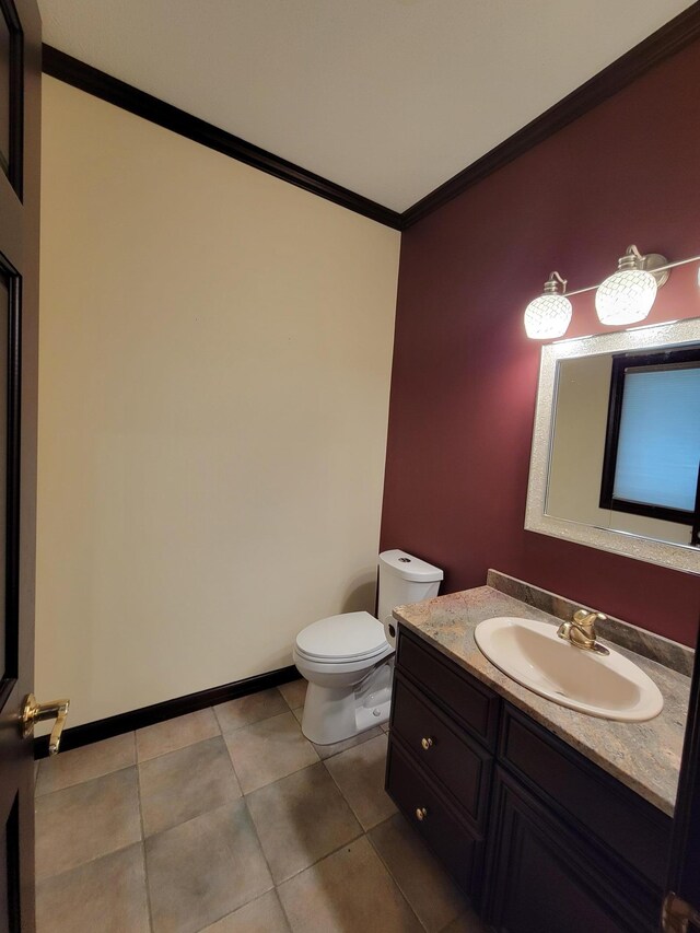 1605 26th St SE, Saint Cloud, MN 56304 - half bath with crown molding, toilet, vanity, tile patterned floors, and baseboards