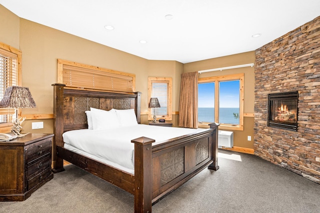 14125-307A Burlington Rd, Two Harbors, MN 55616 - carpeted bedroom with multiple windows, recessed lighting, a stone fireplace, and an AC wall unit