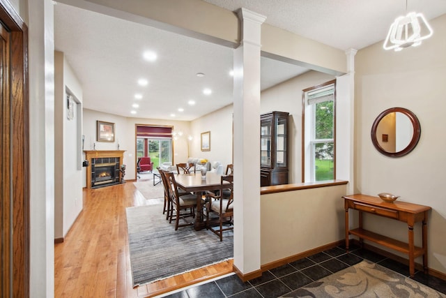 14650 Bloomfield Path, Rosemount, MN 55068 - dining room featuring decorative columns, a tile fireplace, baseboards, recessed lighting, and wood finished floors
