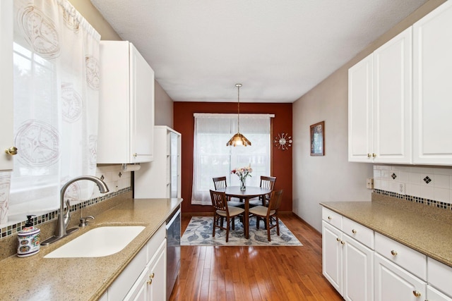 14650 Bloomfield Path, Rosemount, MN 55068 - kitchen with a sink, dishwasher, wood-type flooring, tasteful backsplash, and white cabinets