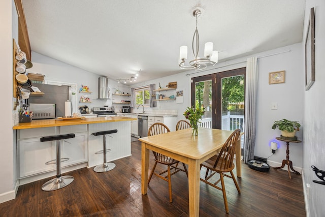 603 2nd Ave NW, Buffalo, MN 55313 - dining space with a chandelier, dark wood-type flooring, and lofted ceiling