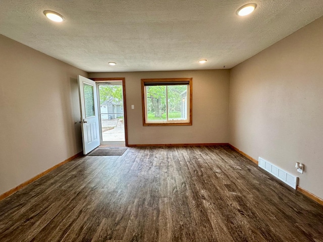 210 160th Ave, Osborne Twp, MN 56128 - empty room with dark wood-style flooring, baseboards, a textured ceiling, and recessed lighting