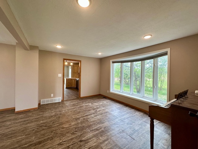 210 160th Ave, Osborne Twp, MN 56128 - empty room featuring baseboards, wood finished floors, recessed lighting, and a textured ceiling