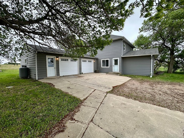 210 160th Ave, Osborne Twp, MN 56128 - view of front facade with driveway, an attached garage, a shingled roof, and a front yard