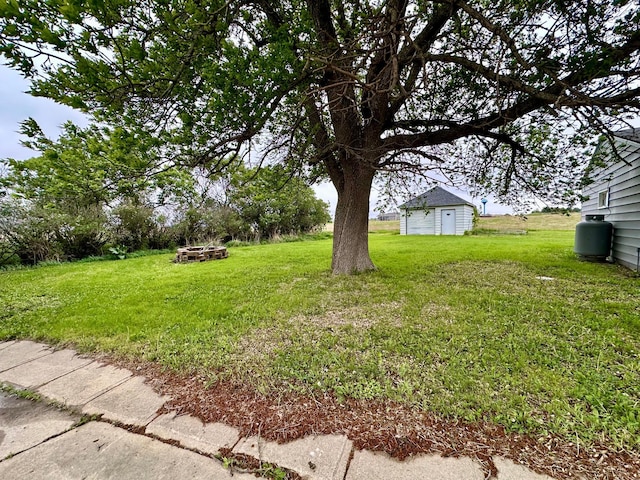 210 160th Ave, Osborne Twp, MN 56128 - view of green lawn featuring an outbuilding, an outdoor fire pit, and a storage unit