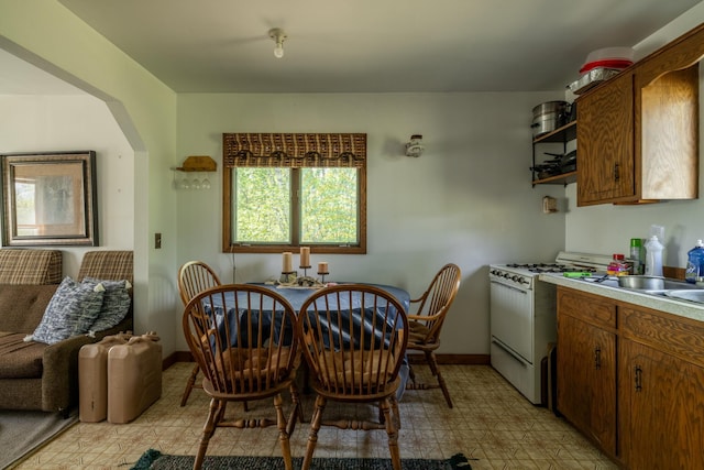 16504 280th St, Park Rapids, MN 56470 - dining room featuring light floors, baseboards, and arched walkways