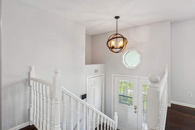 1650 132nd Ave NW, Coon Rapids, MN 55448 - entrance foyer featuring a chandelier, wood finished floors, baseboards, and a textured ceiling