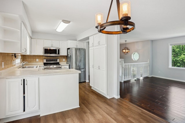 1650 132nd Ave NW, Coon Rapids, MN 55448 - kitchen featuring appliances with stainless steel finishes, a chandelier, open shelves, a sink, and decorative backsplash