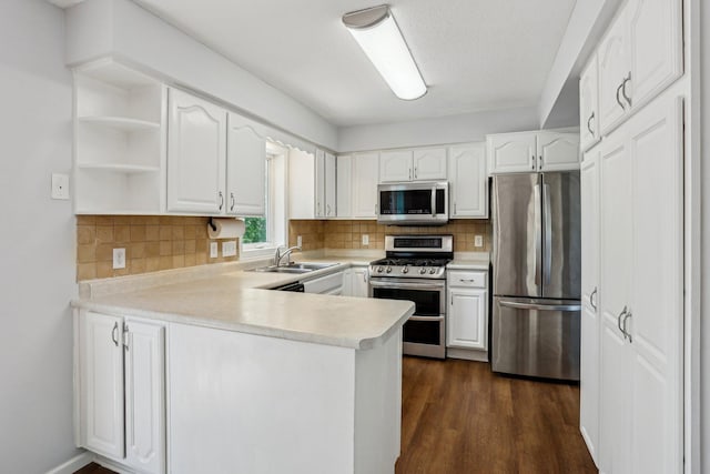 1650 132nd Ave NW, Coon Rapids, MN 55448 - kitchen featuring appliances with stainless steel finishes, a sink, a peninsula, white cabinetry, and open shelves