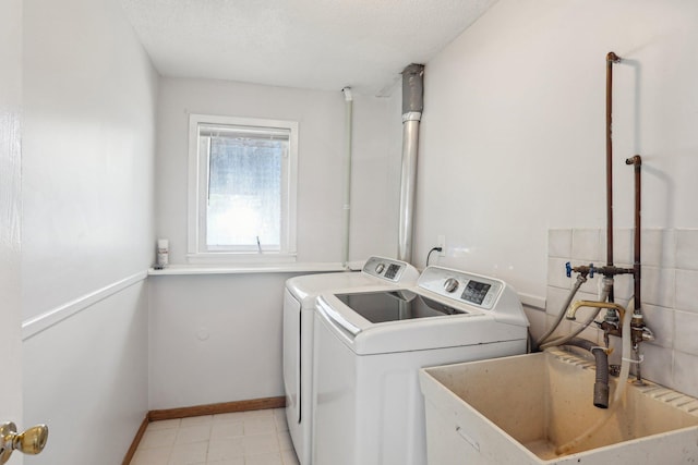 1650 132nd Ave NW, Coon Rapids, MN 55448 - washroom featuring washer and clothes dryer and baseboards