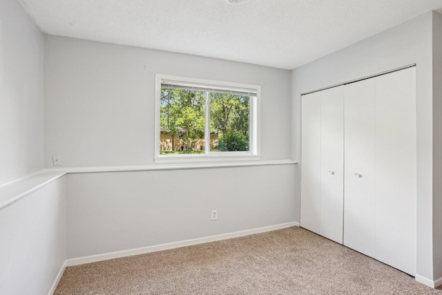 1650 132nd Ave NW, Coon Rapids, MN 55448 - unfurnished bedroom featuring carpet, a closet, and baseboards
