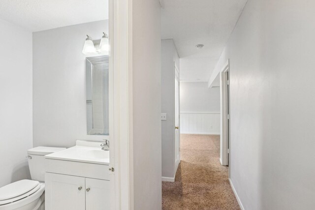1650 132nd Ave NW, Coon Rapids, MN 55448 - bathroom with vanity, toilet, and baseboards