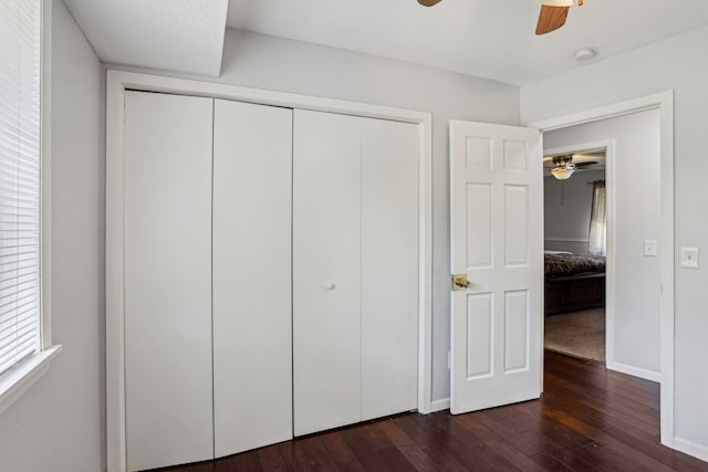 1650 132nd Ave NW, Coon Rapids, MN 55448 - unfurnished bedroom featuring dark wood finished floors, a closet, baseboards, and ceiling fan