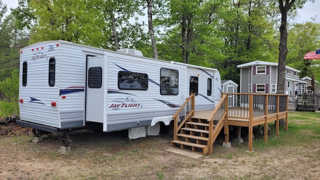 1101 Big Portage Lake Dr NW, Backus, MN 56435 - rear view of property with a shed, a deck, an outdoor structure, and view of scattered trees