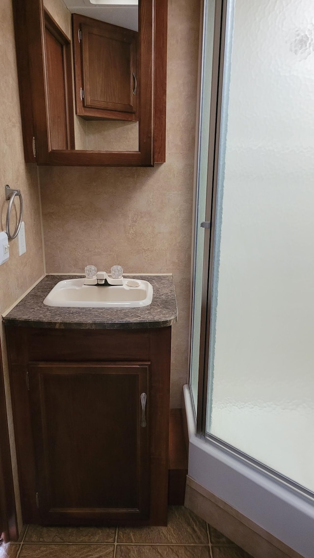 1101 Big Portage Lake Dr NW, Backus, MN 56435 - full bathroom featuring vanity, a stall shower, and tile patterned floors