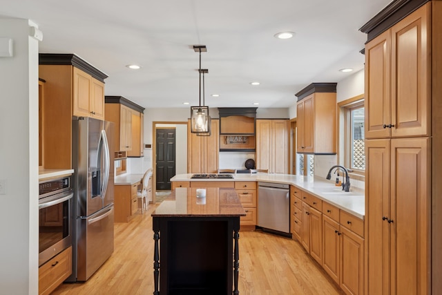 6185 Partridge Ct, Lino Lakes, MN 55110 - kitchen featuring appliances with stainless steel finishes, a sink, recessed lighting, light wood-style flooring, and hanging light fixtures