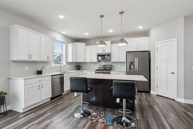 18378 Grasshopper Dr, Lakeville, MN 55044 - kitchen with stainless steel appliances, dark wood-type flooring, light countertops, and recessed lighting