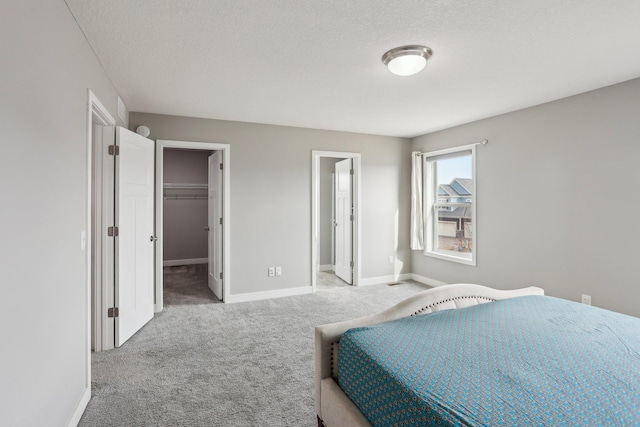 18378 Grasshopper Dr, Lakeville, MN 55044 - carpeted bedroom with baseboards, a spacious closet, a textured ceiling, and a closet