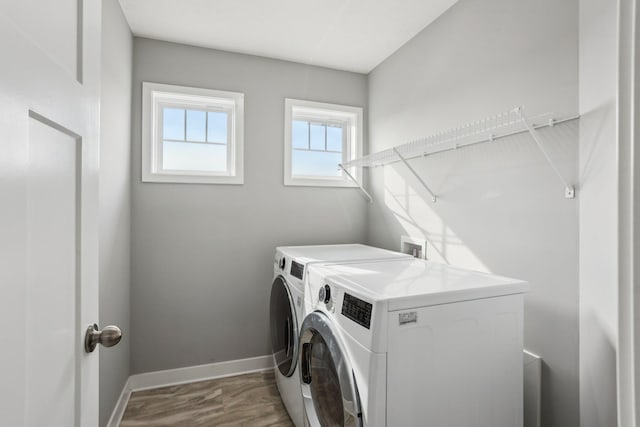 18378 Grasshopper Dr, Lakeville, MN 55044 - laundry area with washing machine and clothes dryer, baseboards, and wood finished floors
