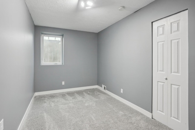 18378 Grasshopper Dr, Lakeville, MN 55044 - empty room with carpet floors, a smoke detector, baseboards, and a textured ceiling