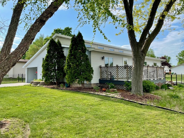 729 10th St E, Wabasha, MN 55981 - view of home's exterior with a lawn, a wooden deck, and concrete driveway