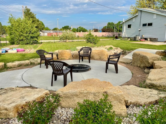 729 10th St E, Wabasha, MN 55981 - view of patio featuring central air condition unit and a fire pit