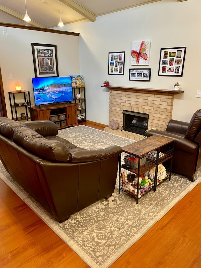729 10th St E, Wabasha, MN 55981 - living room featuring wood finished floors, a brick fireplace, beam ceiling, and baseboards