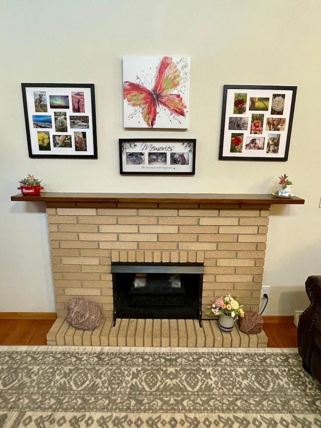 729 10th St E, Wabasha, MN 55981 - detailed view of a brick fireplace, wood finished floors, and baseboards