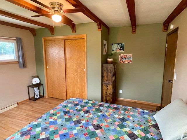 729 10th St E, Wabasha, MN 55981 - bedroom featuring beamed ceiling, wood finished floors, baseboards, a closet, and a ceiling fan