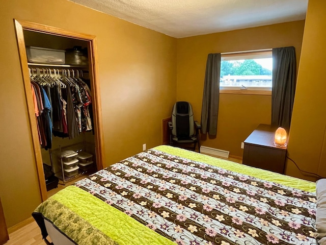 729 10th St E, Wabasha, MN 55981 - bedroom featuring a closet, light wood-style floors, and a textured ceiling