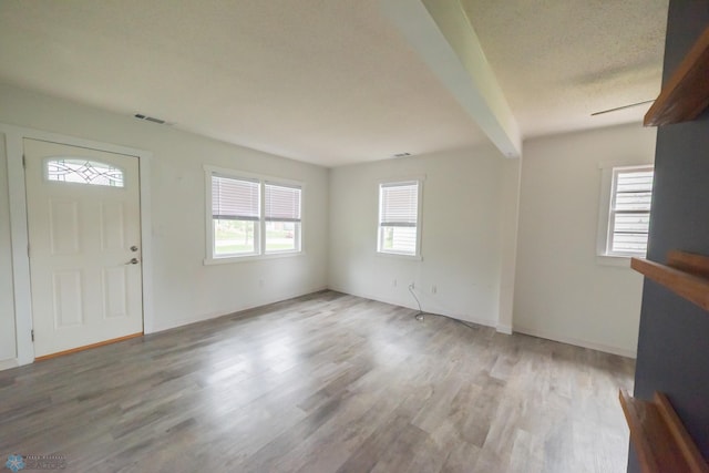 foyer with wood finished floors and baseboards