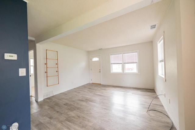 foyer entrance featuring wood finished floors and baseboards