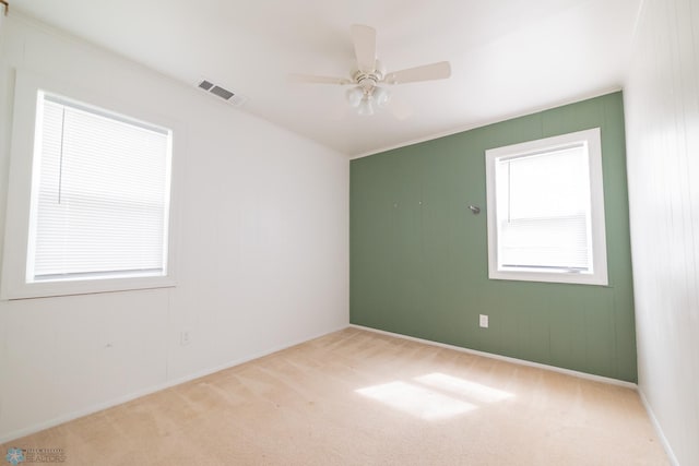 spare room with carpet flooring, ceiling fan, and baseboards