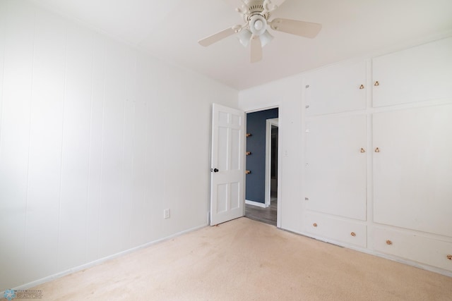 unfurnished bedroom featuring light carpet and ceiling fan
