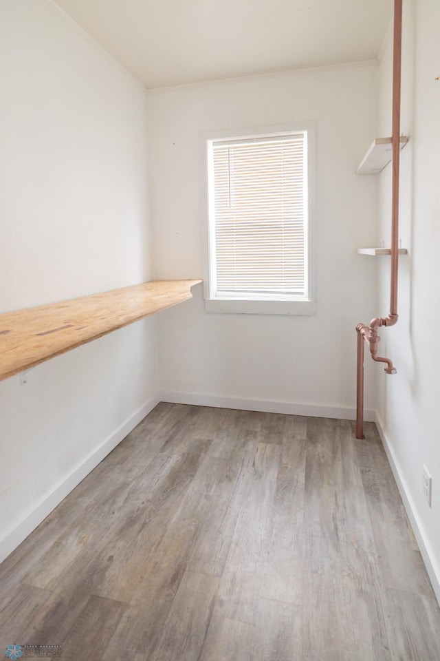 spare room featuring wood finished floors and baseboards