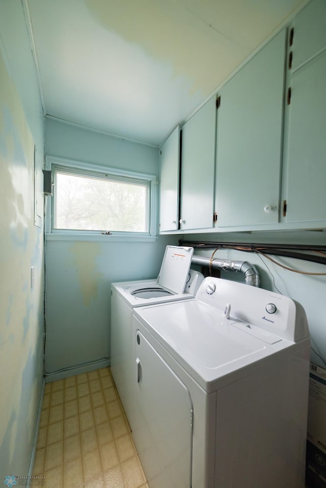 laundry room featuring cabinet space, separate washer and dryer, light flooring, and baseboards