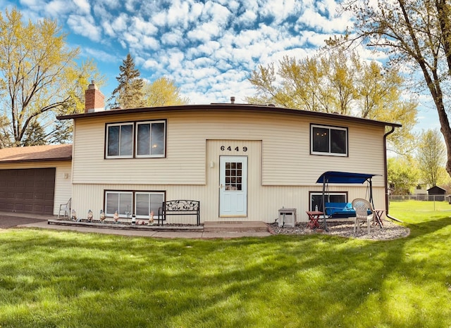 6449 Rice Ct, Lino Lakes, MN 55014 - back of house with a chimney and an attached garage