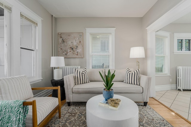 living room with radiator, wood finished floors, and baseboards