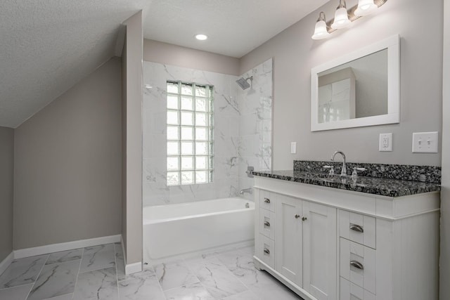 full bathroom with marble finish floors, baseboards, washtub / shower combination, vanity, and a textured ceiling
