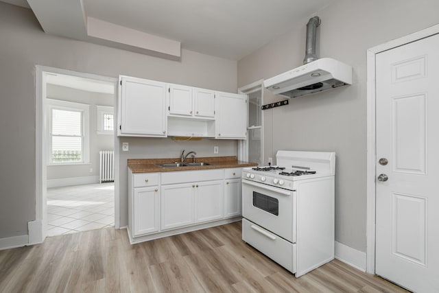 kitchen with white range with gas stovetop, radiator heating unit, under cabinet range hood, open shelves, and white cabinetry